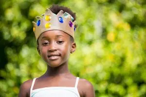 portrait-of-a-mixed-race-girl-smiling-and-wearing-a-crown-1536x1024