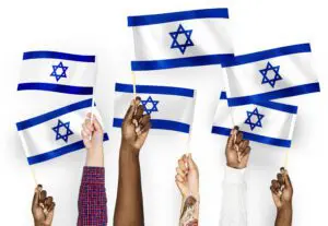 Hands waving flags of Israel