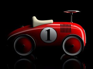 red-retro-toy-car-number-one-isolated-on-black-background