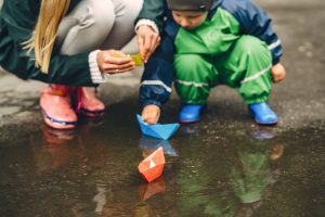 funny-kid-in-rain-boots-playing-in-a-rain-park
